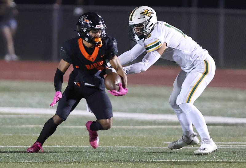 DeKalb's Xavier Dandridge tries to get away from a Waubonsie Valley defender during their game Friday, Sept. 29, 2023, at DeKalb High School.