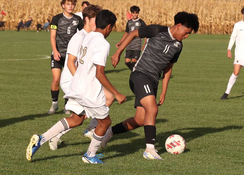 Kaneland's Abe Paulino avoids two Sycamore players during their game Monday, Oct. 7, 2024, at Kaneland High School in Maple Park.