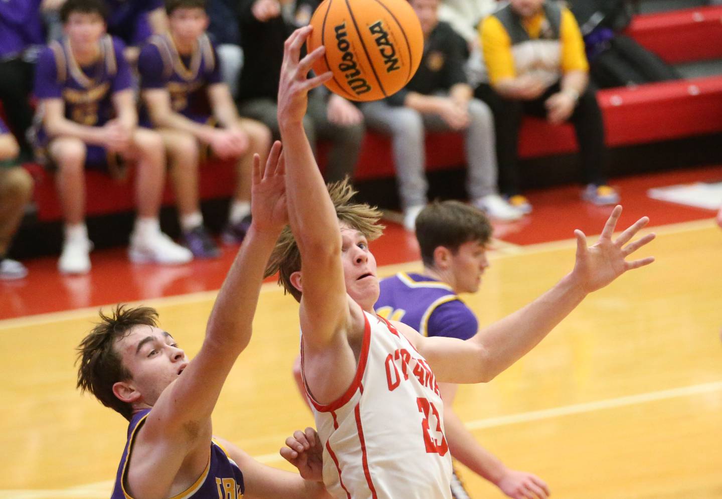 Ottawa's Owen Sanders grabs a rebound over Mendota's Braiden Freeman on Tuesday, Jan. 7, 2025 in Kingman Gym at Ottawa High School.