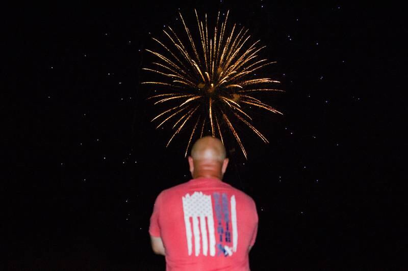 Ottawa man watches firework display on Thursday, July 4, 2024 at Ottawa High School.
