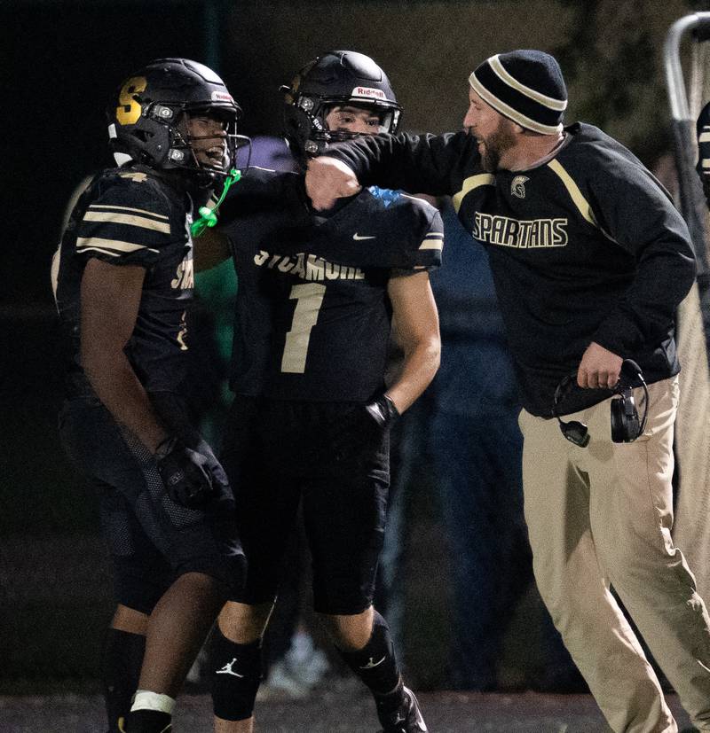 Sycamore's Tyler Curtis (left) reacts after intercepting a pass against Kaneland during a football game at Kaneland High School in Maple Park on Friday, Sep 30, 2022.