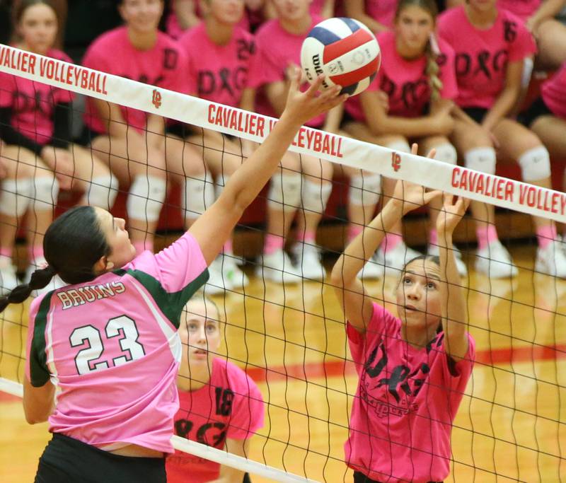 St. Bede's Ali Bosnich sends a spike past L-P's Addison Urbanski and teammate Olivia Weber during the "Cavs 4 A Cause" pink night game on Tuesday, Sept. 26, 2023 at Sellett Gymnasium.