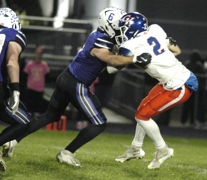 Genoa-Kinsgton's  Jaden Lee is wrapped up by Dixon's Logan Mershon. Genoa-Kingston traveled to Dixon to take on the Dukes. The game took place on Dixon's Senior Night, October 24th, 2025