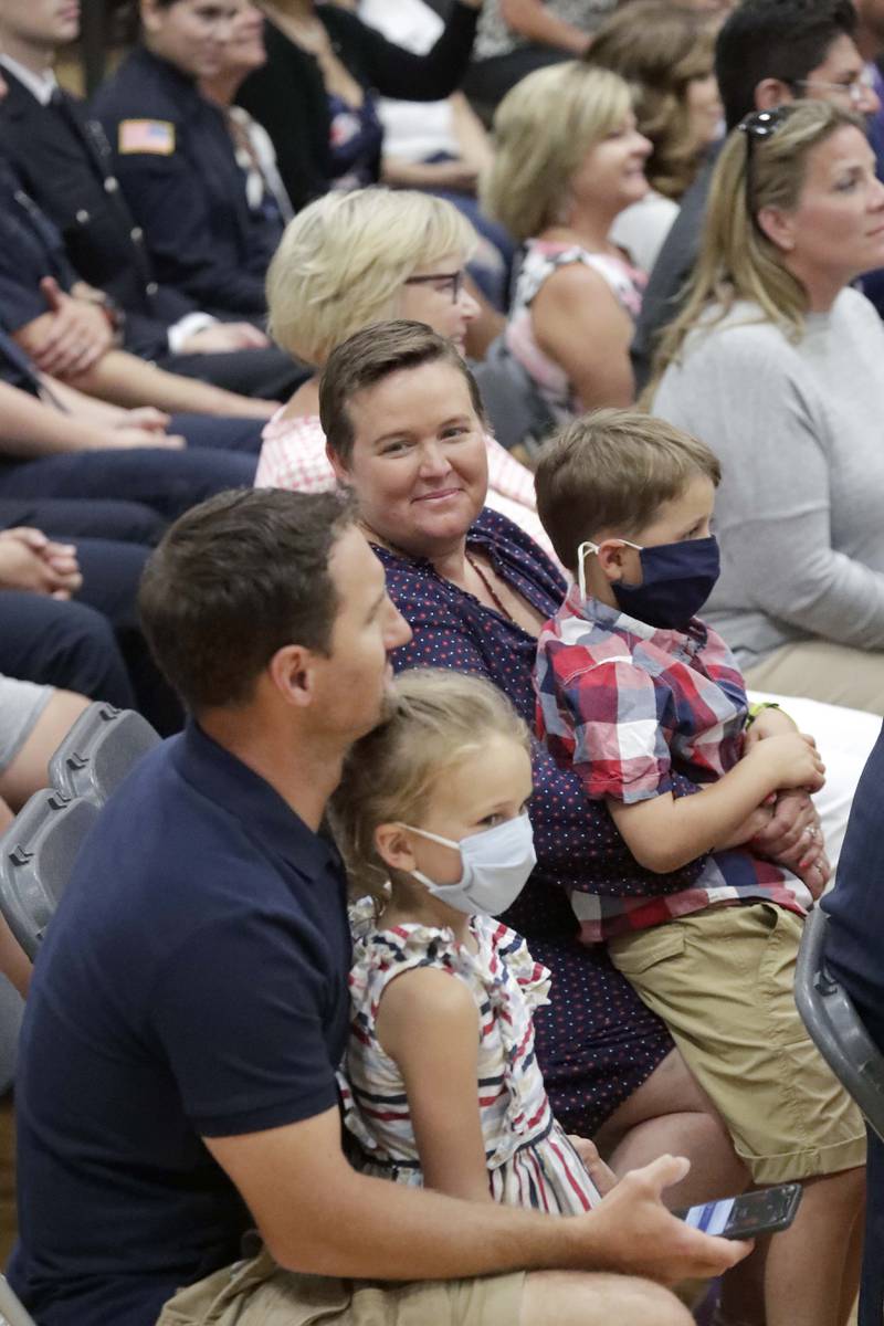 Sarah Fisher; her son Charlie, 8; and husband, Brett, with daughter Analee, 6, all of Crystal Lake, listen to President Joe Biden, speaks at McHenry County College Wednesday, July 7, 2021, in Crystal Lake.