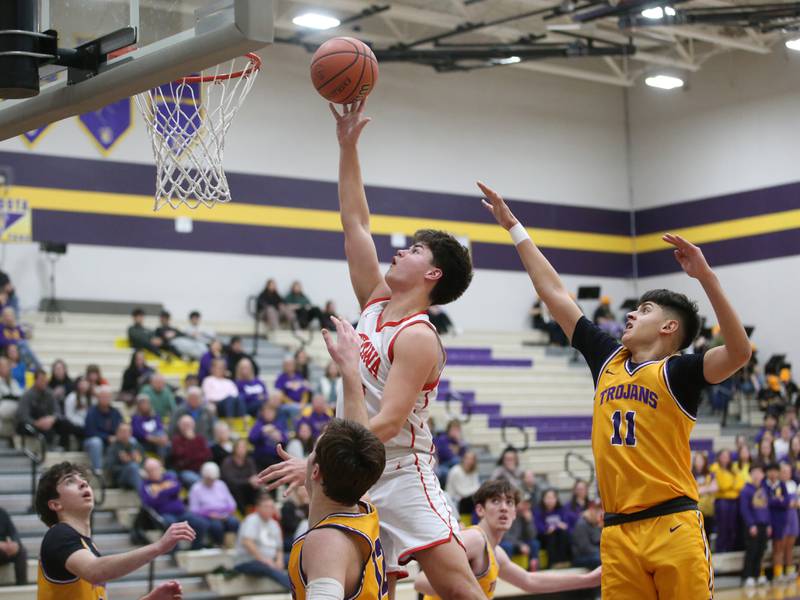 Ottawa's Cooper Knoll drives to the hoop as Mendota's Braiden Freeman and Iziah Nenez defend on Tuesday, Feb. 13, 2024 at Mendota High School.