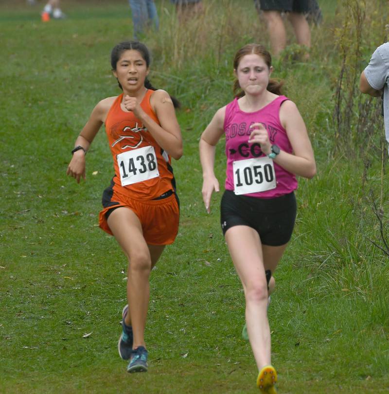 Sandwich's Joanna Rivera sprints to the finish line against Aurora Rosary's Olivia Kuno at the Amboy Cross Country Invitational on Monday.