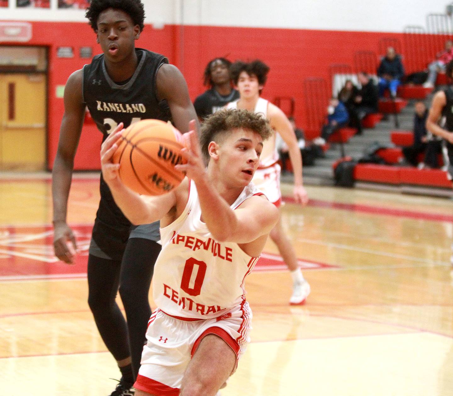 Naperville Central's Alex Liabo holds onto a rebound during a game against Kaneland on Tuesday, Jan. 14, 2025 in Naperville.