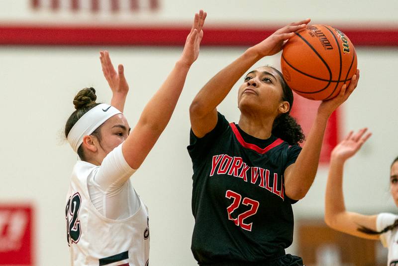 Yorkville's Alexandra Stewart drives to the basket against Plainfield North's Kaitlyn Sedillo during a Yorkville girls 4A regional semifinal basketball game at Yorkville High School on Tuesday, Feb 14, 2023.