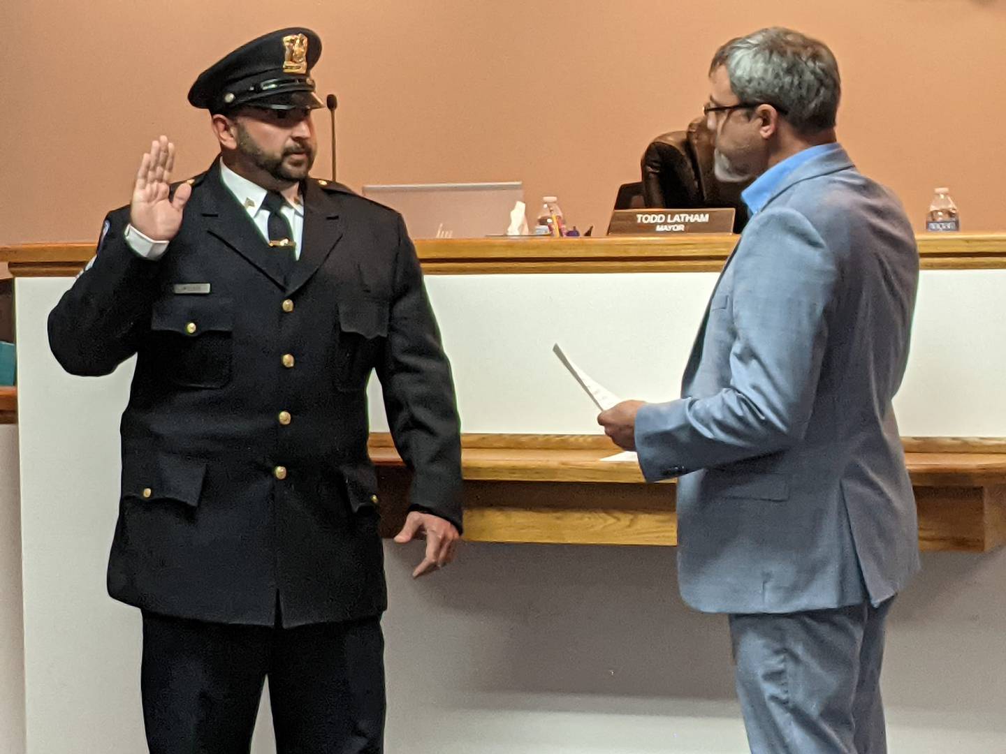 Sandwich Mayor Todd Latham, right, swears in William Meisner, left, as the new sergeant on the Sandwich Police Department during the June 17 Sandwich City Council meeting.