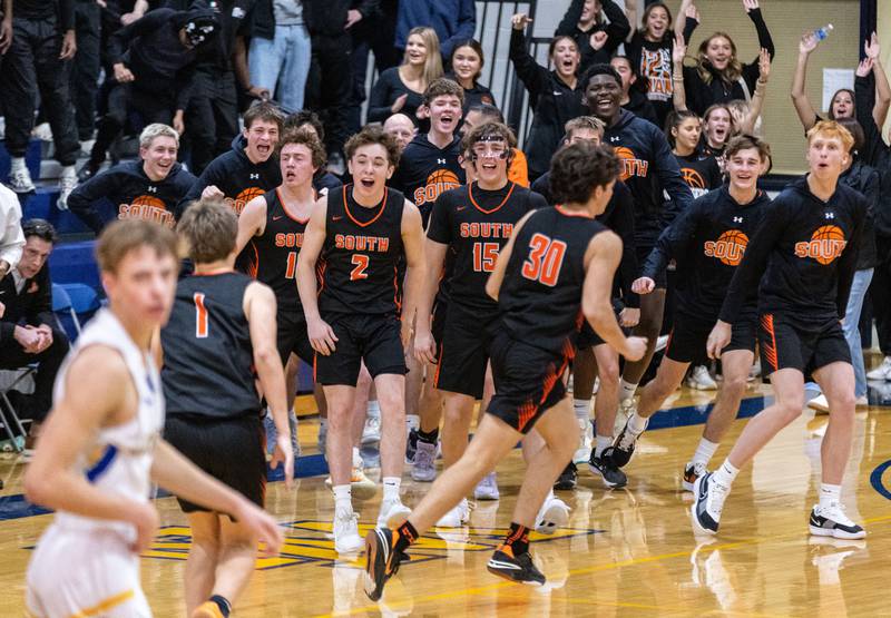 Wheaton Warrenville South’s boys basketball team celebrates their win against Wheaton North on Friday, Dec. 20, 2024.