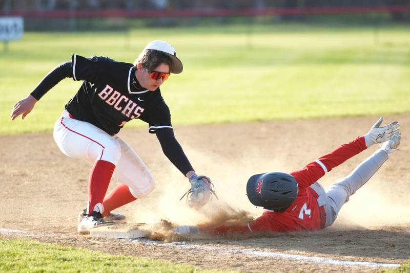 Bradley-Bourbonnais' Kason Bynum, left, reaches to apply a late tag on Homewood-Flossmoor's Mateo Morales during a game at Bradley-Bourbonnais Friday, April 11, 2025.