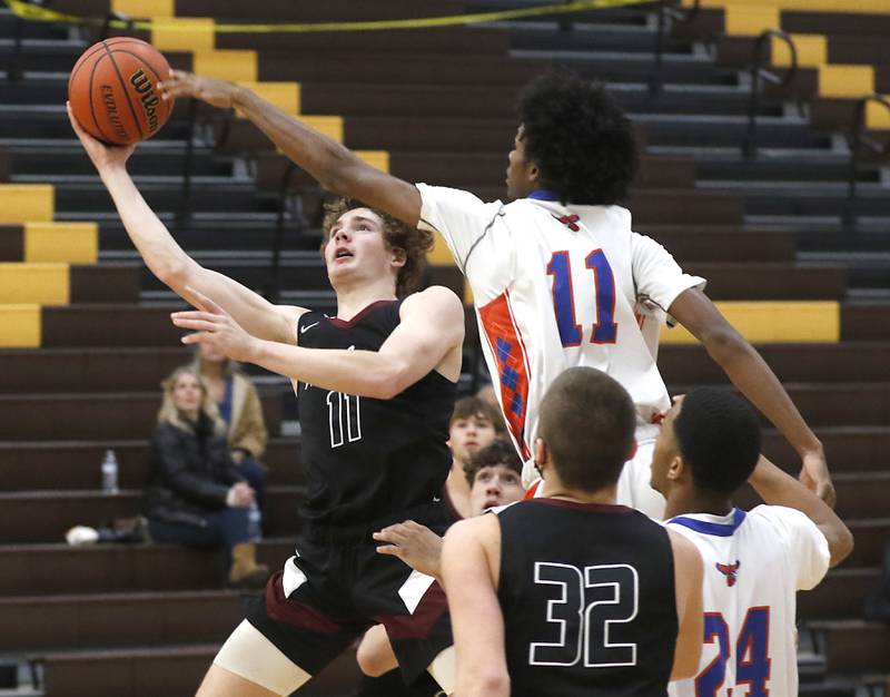 Prairie Ridge's James Muse drives to the basket against Hoffman Estates’ DJ Wallace during a Hinkle Holiday Classic basketball game Wednesday, Dec. 28, 2022, at Jacobs High School in Algonquin.