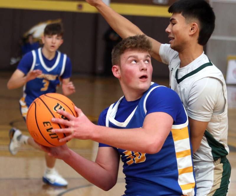 Johnsburg’s Jayce Schmitt looks to the hoop as Boylan’s Madden Fuehrer defends in varsity boys basketball Hinkle Holiday Classic action on Tuesday, Dec. 23, 2025, at Jacobs High School in Algonquin.