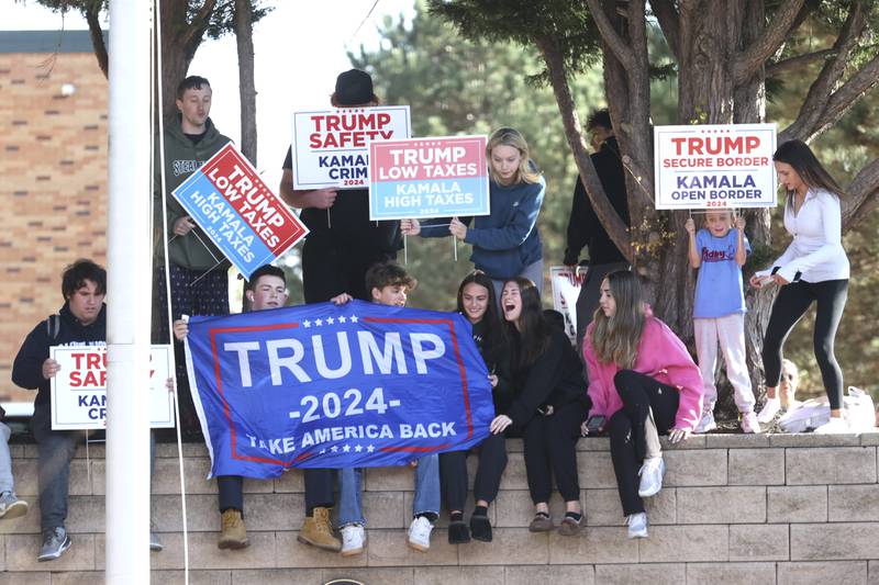 Young Trump supporters gather outside Ridley High School before Elon Musk leads a America PAC Town Hall in Delaware County, Pa., at Ridley High School on Thursday, Oct. 17, 2024.  (Charles Fox/The Philadelphia Inquirer via AP)