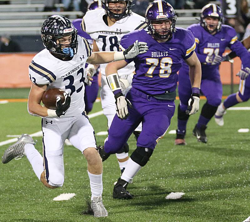 IC Catholic's Joey Gliatta (33) turns upfield to run the ball past Williamsville's John Layman (78) in the Class 3A State title game on Friday, Nov. 25, 2022 at Memorial Stadium in Champaign.