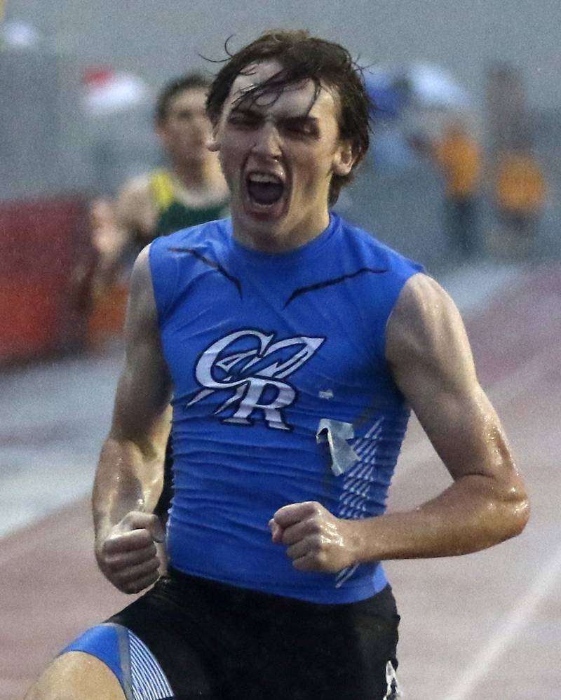 Burlington Central’s Nolan Milas celebrates winning the 400 meter run during the Fox Valley Conference Boys Track and Field Meet at Huntley High School.