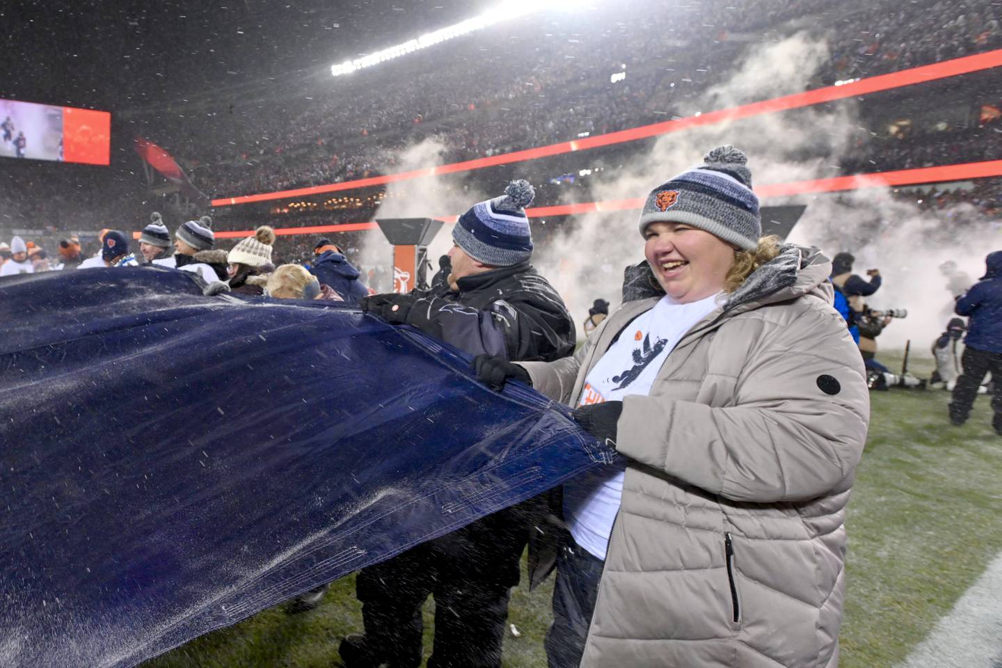 Ashley Vilona, Advocate Health Care’s 2025 Nurse Leader of the Year, was all smiles as she helped unfurl the giant flag during pregame introductions for the Bears’ playoff matchup against the Los Angeles Rams.