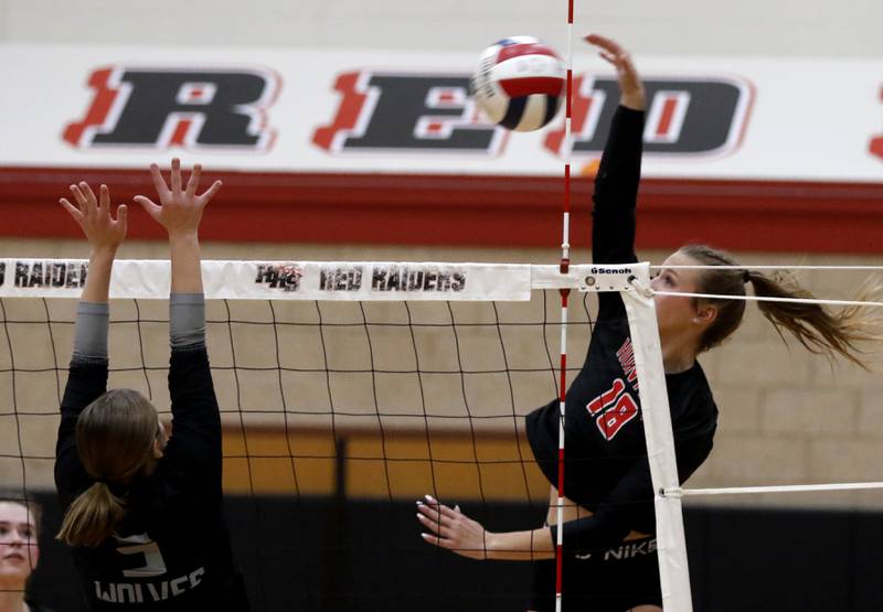 Huntley's Sienna Robertson (right) spikes the ball as Prairie Ridge's Grace Jansen goes up to block during a Fox Valley Conference volleyball match on Tuesday, Oct. 8, 2024, at Huntley High School.
