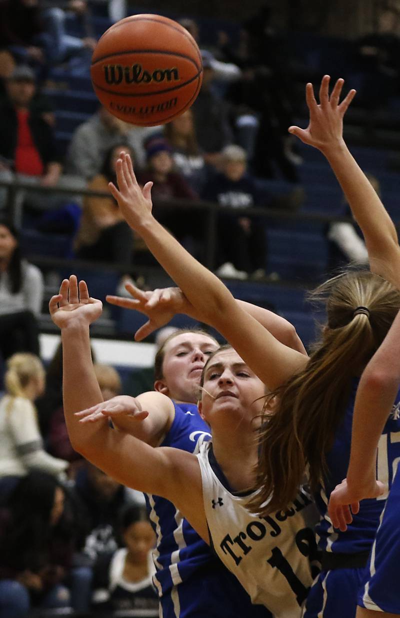 Cary-Grove's Malaina Kurth is fouled by Burlington Central's Emily Menke as she drives to the basket between Menke and Burlington Central's Haley Lindquist during a Fox Valley Conference girls basketball game Friday Jan. 6, 2023, at Cary-Grove High School in Cary.