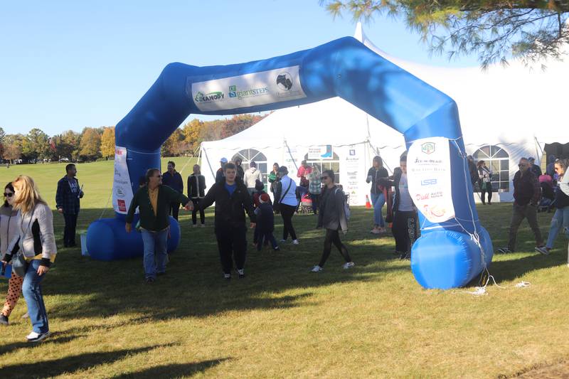 Racers and supporters gather at the finish line of the Giant Steps Boot Scootin' for autism 5K on Oct. 26, 2024.