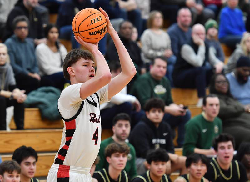 Benet’s Daniel Pauliukonis shoots a three pointer in front of the St. Patrick bench during a game on January 17, 2025 at Benet Academy in Lisle.