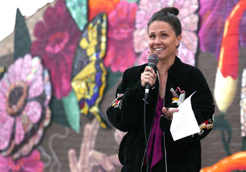 Mural artist Danielle Casali speaks Thursday, Oct. 19, 2023, during the unveiling and ribbon cutting of the new City Hall mural she created. The mural is on the on the south wall of City Hall and was completed with the help of many volunteers who wanted to be a part of the project..