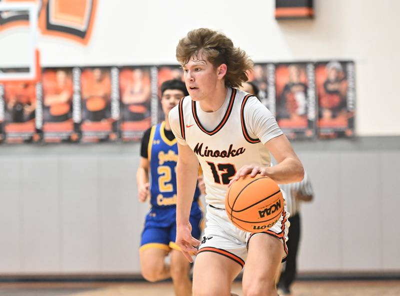 Minooka's Zane Caves (12) dribbling the ball up court during a conference game against Joliet Central on Friday, Jan. 10, 2025, at Minooka.