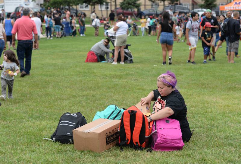 Doris Bonilla of Cicero  arranges her children's backpacks while attending the Back to School Fair held at the Cicero Community Park Sunday Aug 13, 2023.