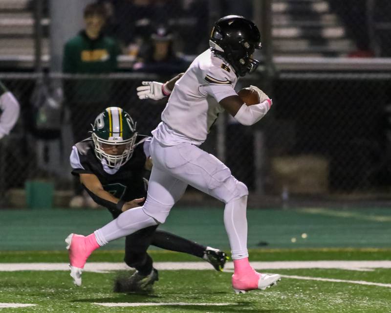 Joliet West's Micah Mcnair (8) avoids a tackle attempt by Plainfield Central's Matt Leto (7) on the way to the endzone after a late interception during football game between Joliet West at Plainfield Central.   Oct 20, 2023.