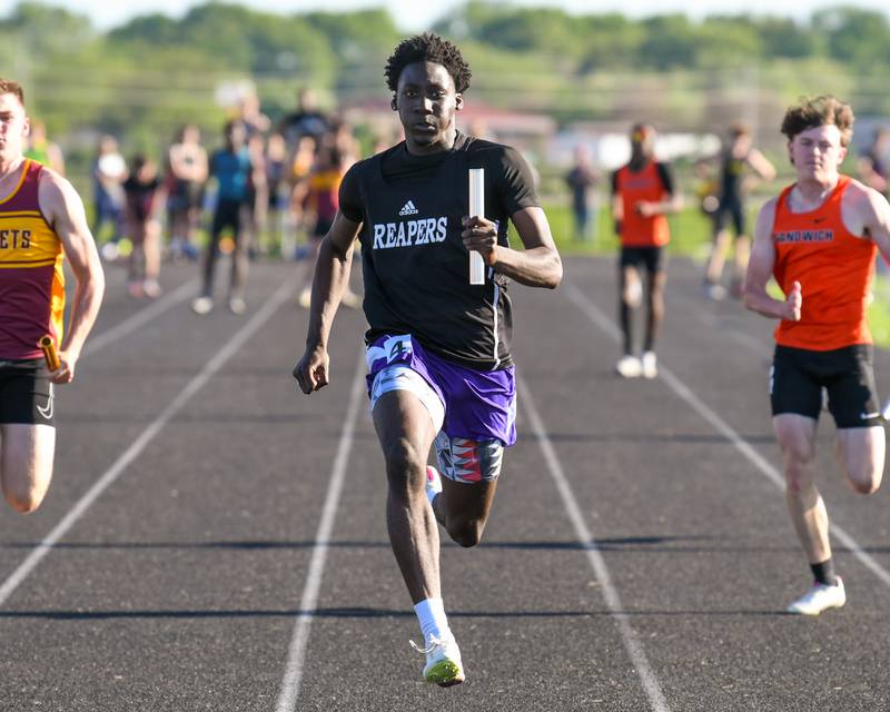 Christ Keleba crosses the finish line during the 100 meter relay at the Kishwaukee River Conference track meet on Tuesday May 7, 2024, held at Plano High School.
