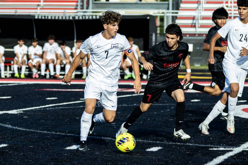 Minooka's Ethan Koranda and Bolingbrook's Jona Tapia fight for control of the ball during a varsity soccer game at Bolingbrook on Sept. 16, 2025.