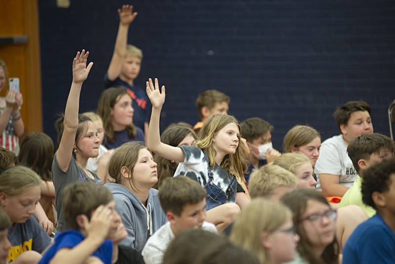 Fifth-grade students at Sterling's Washington School raise their hands for questions to three-time Paralympic gold-medal winning sled hockey player Kevin McKee.
