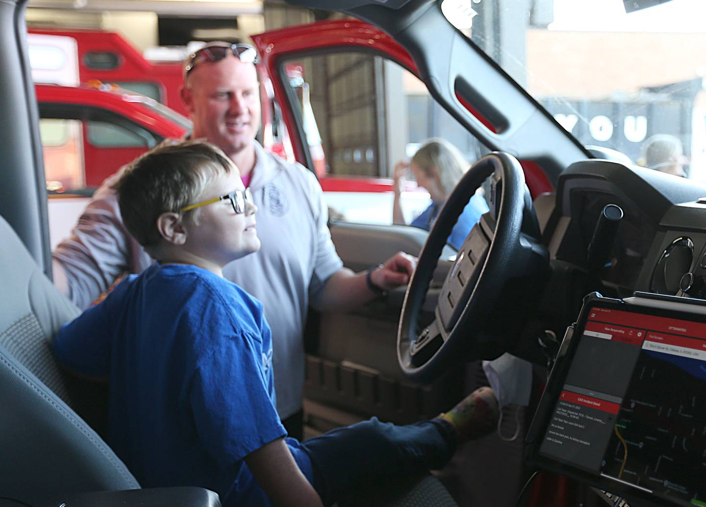 Parker Vangalder 6, of Seneca, climbs into an ambulance with Ottawa Lieutenant Kevin Theis at the Ottawa Fire Department on Monday, Oct. 10, 2022. Vangelder and his family are going to Walt Disney World later this month courtesy of Make-A-Wish.