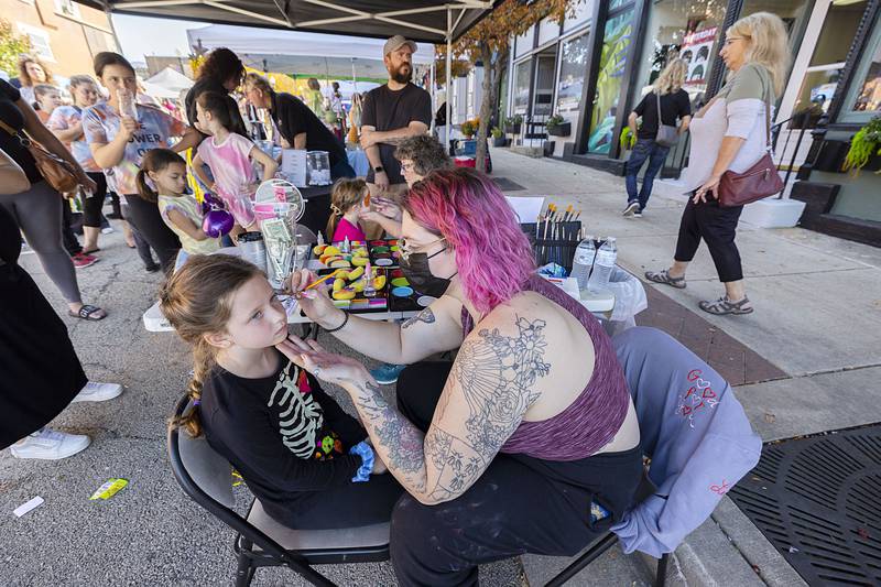 Maddilyn Sexton, 8, of Rock Falls gets some new face art from Evanne Deatherage Saturday, Oct. 22, 2022 during Dixon’s Scarecrow Fest. Deatherage was adding a pop of color for the Dixon Children’s Theater group who had a booth downtown. The group will be performing Annie Jr. in November.
