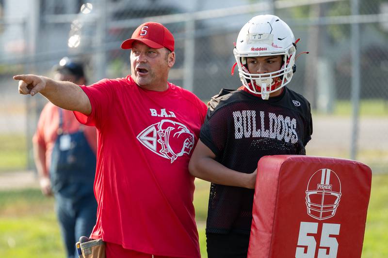 (left to right) Coach Jason Schultz points at drill as TJ Horton of Streator holds pad on Monday, August 11, 2025 at Streator High School in Streator.