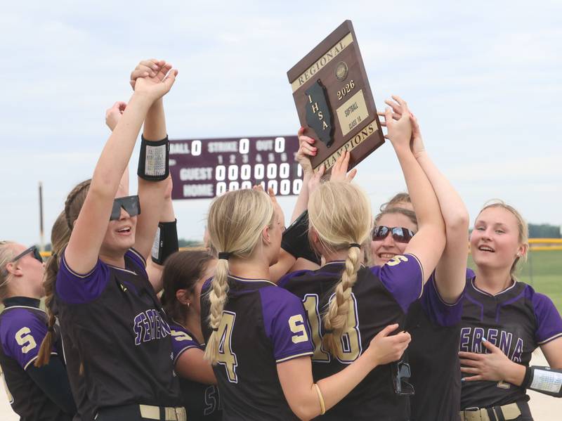 Members of the Serena softball team hoist the Class 1A Regional plaque after defeating Marquette 2-1 on Friday, May 22, 2026 at Serena High School.