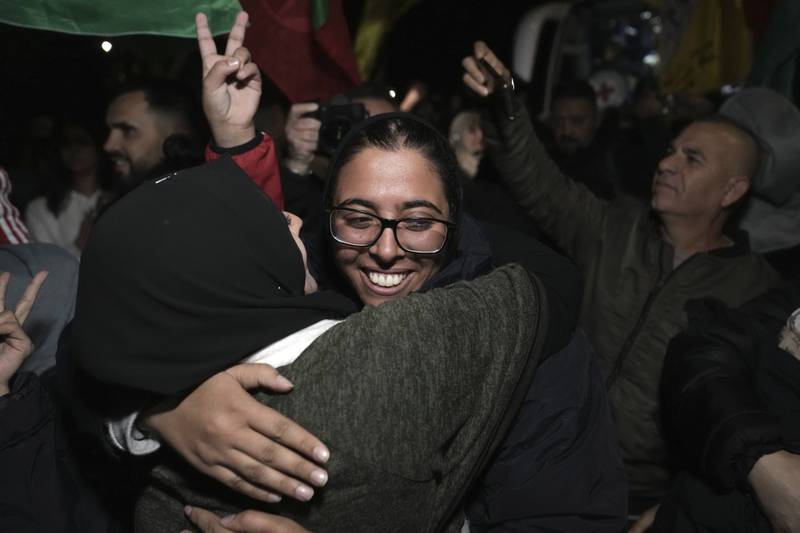 Palestinian prisoner Fairuze Salameh is greeted after she was released, in the West Bank town of Ramallah, early Wednesday Nov. 29, 2023. Hamas and Israel released more hostages and prisoners under terms of a fragile cease-fire that held for a fifth day Tuesday. (AP Photo/Nasser Nasser)