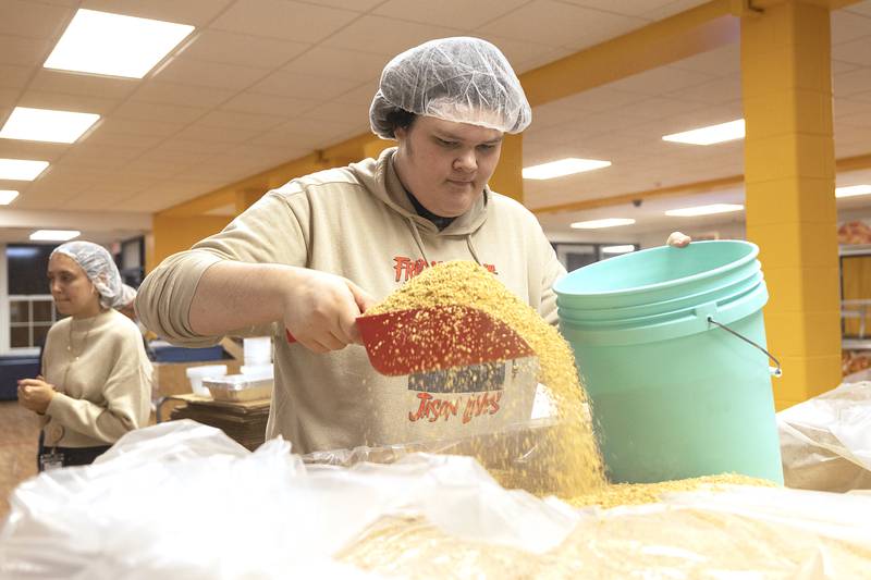 Drayden Welch of Sterling scoops up soy protein Wednesday, Nov. 6, 2024, to start the meal building.