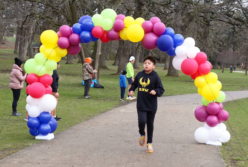 Alan Alanis, 9, crosses the finish line at the Color Outside the Line 5K that was held in Geneva on April 5, 2025.