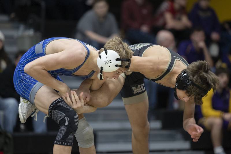 Newman’s Landon Near grabs the leg of Mercer County’s Boston Morford in the 113 pound finals Saturday, Jan. 31, 2026, during the Class 1A Wrestling Regionals at Riverdale High School. Near won 10-1.