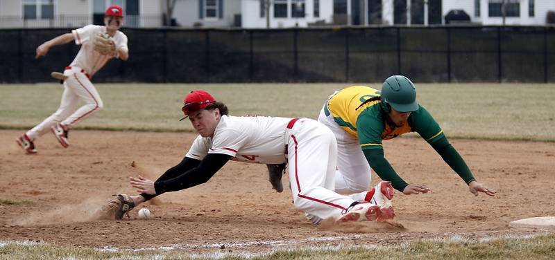 Huntley's Tommy Gasner looses the ball as Fremd’s Santino lacullo dives back to first base during a nonconference baseball game against Fremd on Tuesday, March 24 2026, at Huntley High School.