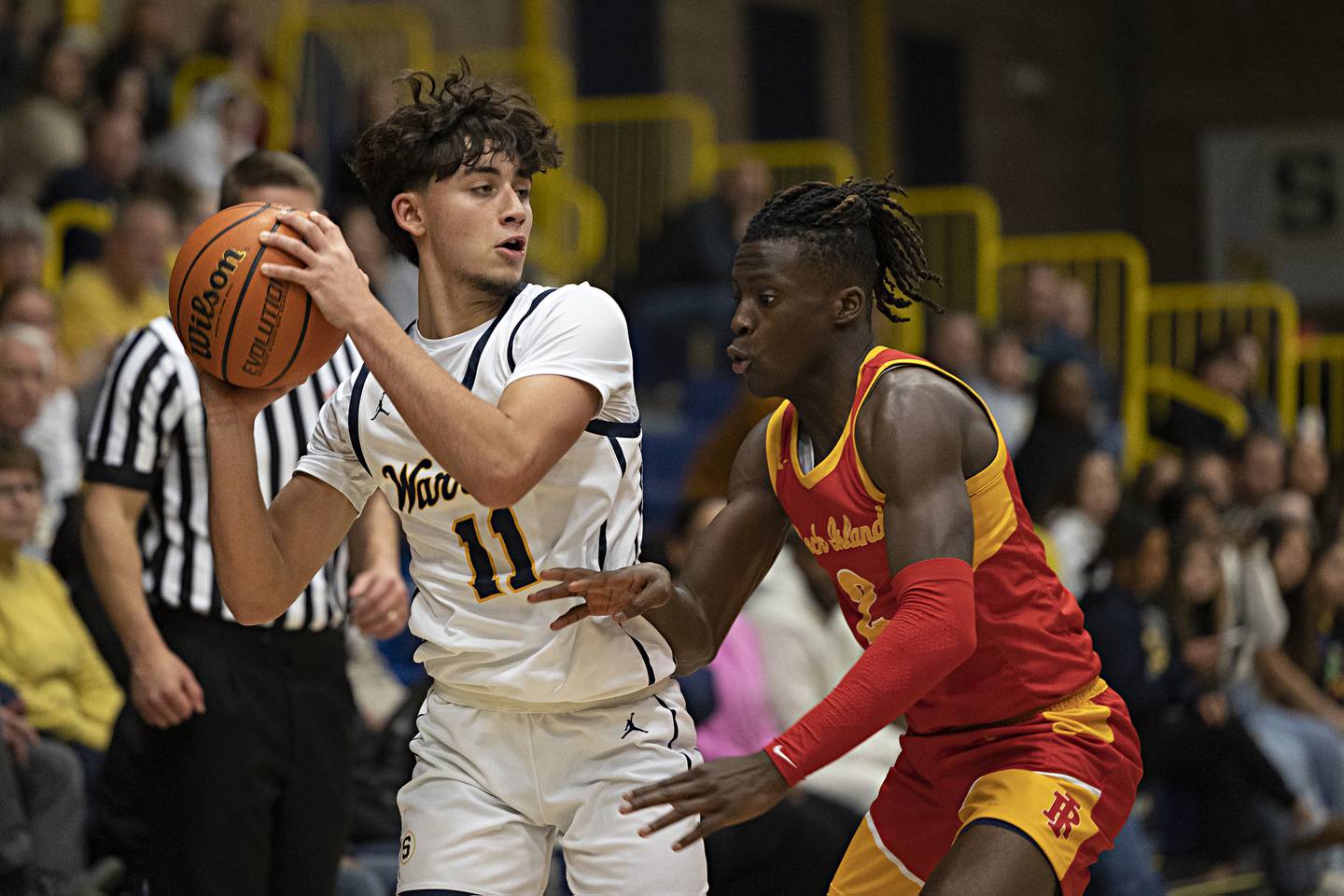 Sterling’s Nico Battaglia looks to pass while being defended by Rock Island’s Ben Goen Tuesday, Dec. 5, 2023 at Sterling High School.