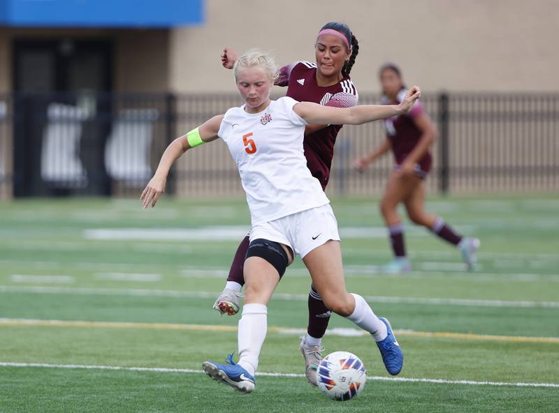 Crystal Lake Central's Liz Gray (5) handles the ball as St. Ignatius' Sofia Knoepp (8) closes in during the 2A girl's varsity supersectional soccer match between Crystal Lake South and St. Ignatius high schools on Tuesday, June 3, 2025 in Chicago.