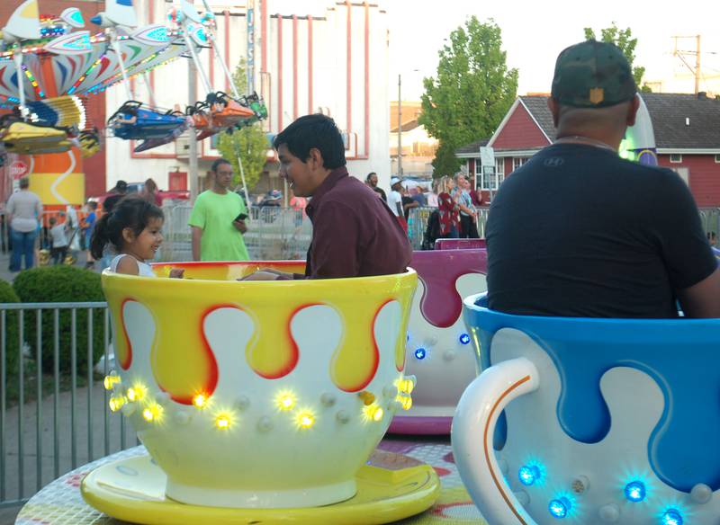 A family goes for a spin on the teacup ride at Streator Park Fest on Friday, May 26, 2023 in downtown Streator.