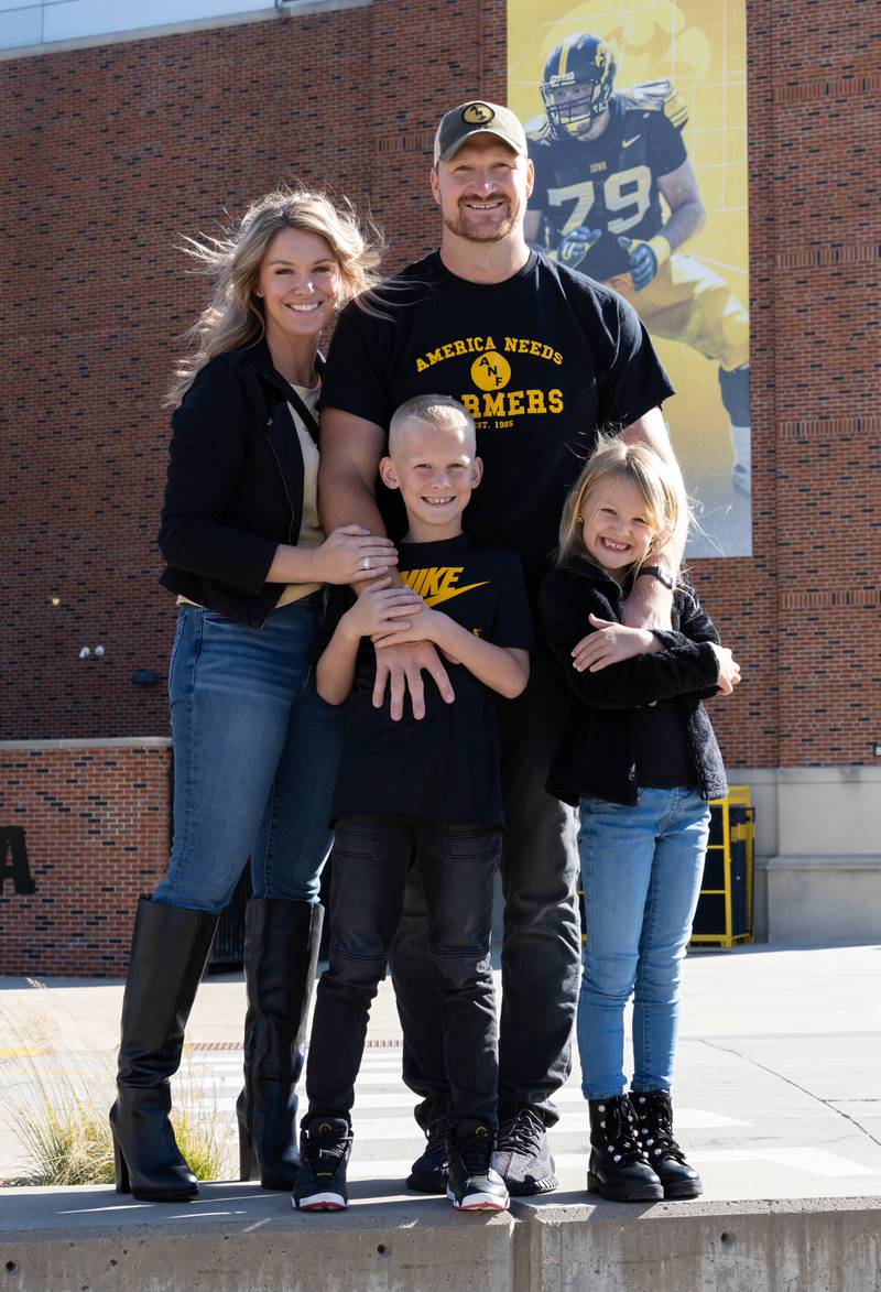 Marian Central graduate Bryan Bulaga and his wife Abbie, with children Declan (8) and Cameron (6), outside Iowa's Nile Kinnick Stadium this season, where Bryan was the 2023 America Needs Farmers Wall of Honor recipient.