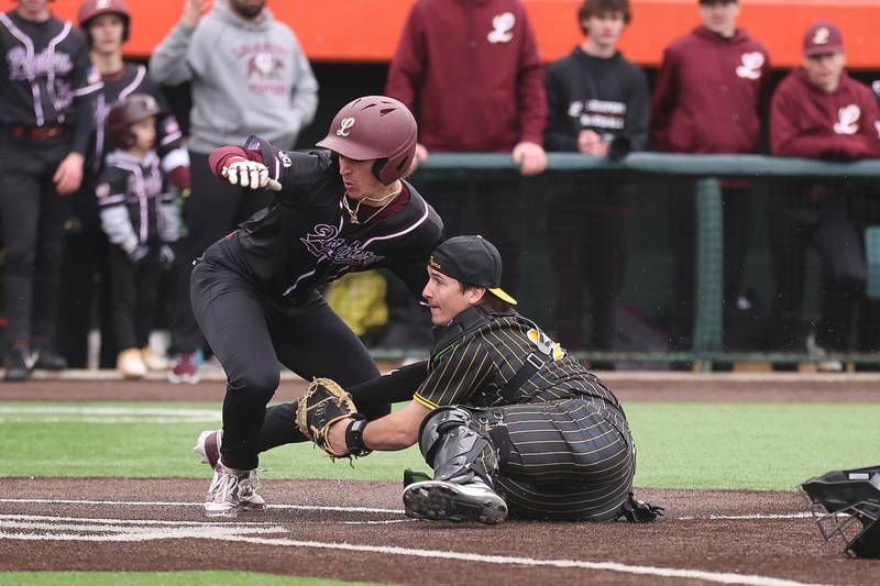 Joliet West’s Travis Skole prevents the go-ahead run by tagging out Lockport’s David Kundrat in the WJOL Don Ladas Memorial baseball tournament championship game on Saturday, April 4, 2026 in Joliet.