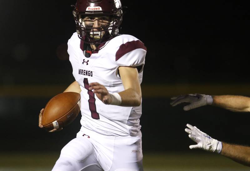 Marengo’s David Lopez runs away from a Johnsburg defender while scrambling iduring a Kishwaukee River Conference football game on Friday, Sept. 15, 2023, at Johnsburg High School.