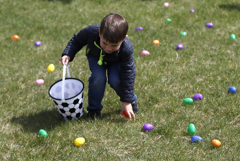 Vinny Puccio, 3 1/2, picks up eggs on Saturday, April 19, 2025, during the Johnsburg Easter Egg Hunt at Sunnyside Memorial Park, in Johnsburg. Children hunted for 6,000 candy-filled eggs in three hunts divided by age group.