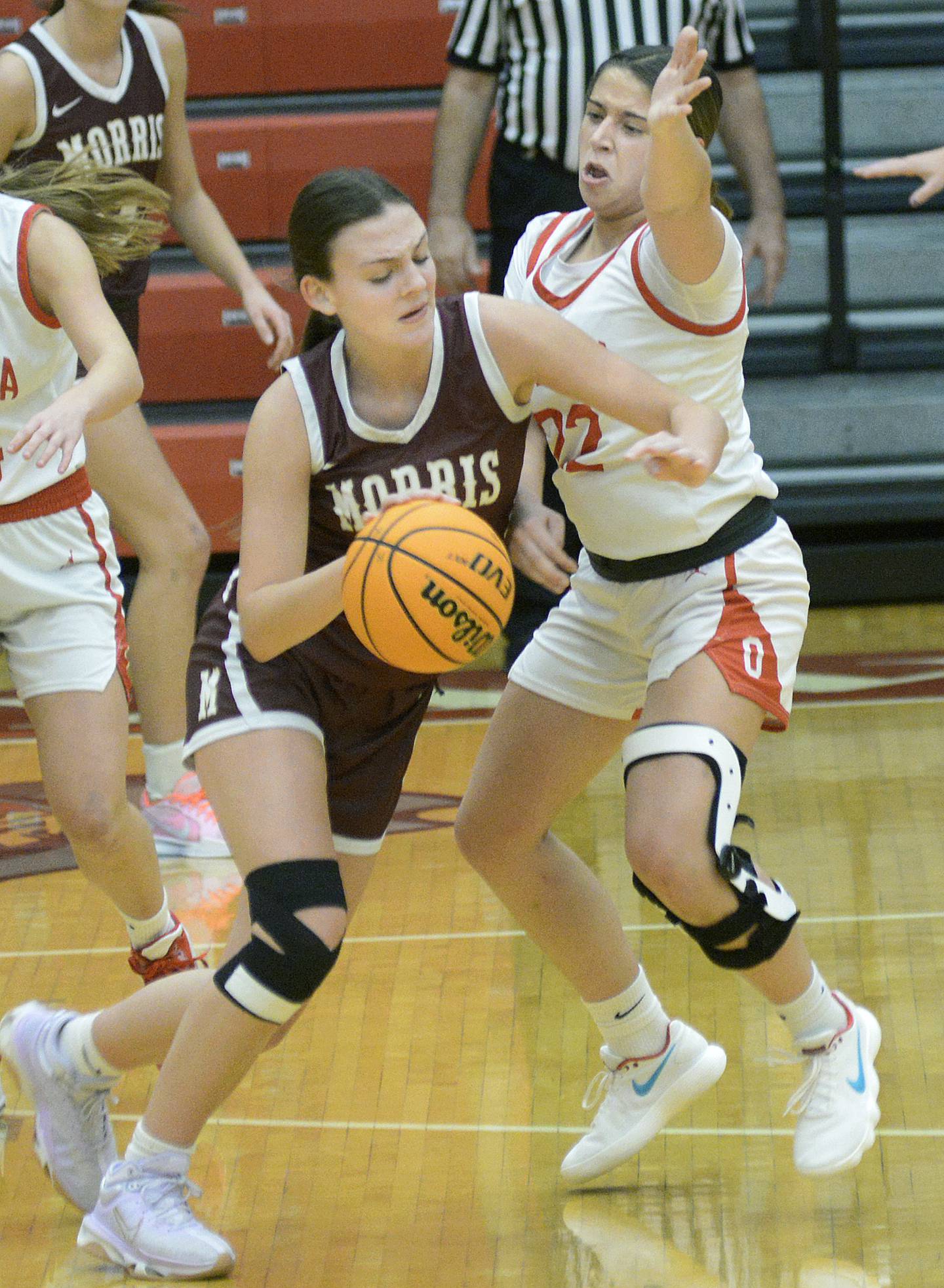 Morris’s Lily Hansen works to get around Ottawa’s Marlie Orlandi on a drive in the second quarter of Saturday's championship game of the Ottawa Holiday Tournament.