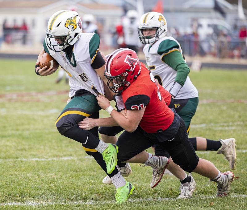 Amboy’s Quinn Leffelman hauls down St. Thomas More’s Matt Delorenzo Saturday, Nov. 12, 2022 during the 8-man semifinals.